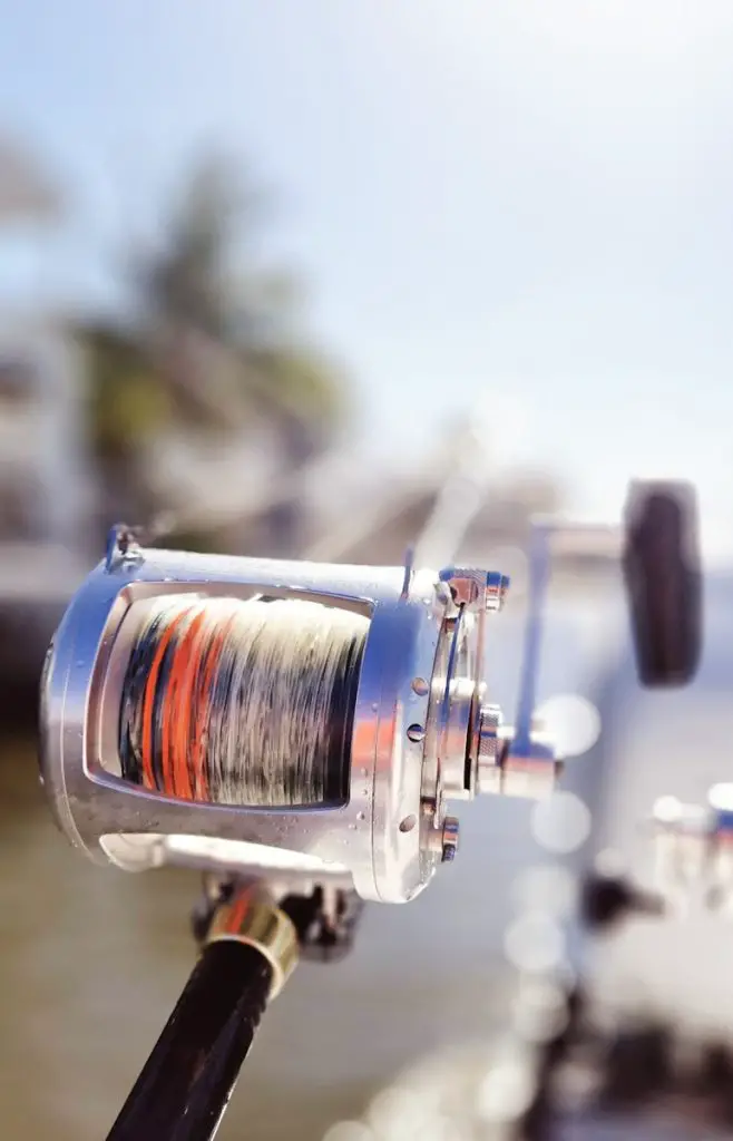 a close up of a fishing reel on a boat